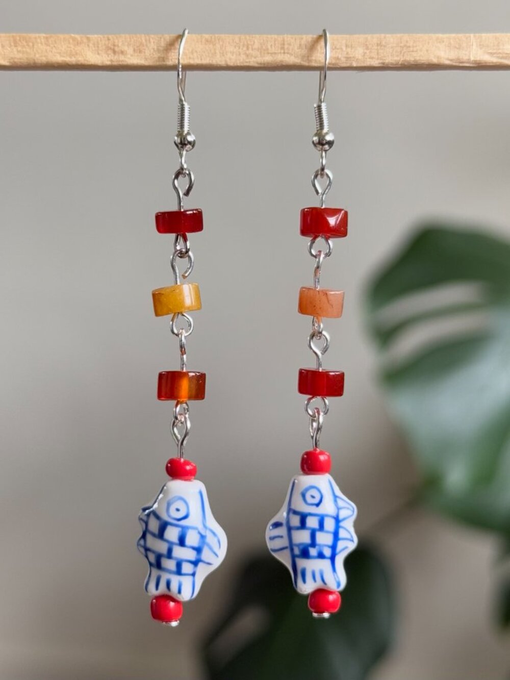 handmade earrings with red heishi beads & dangling blue & white ceramic fish
